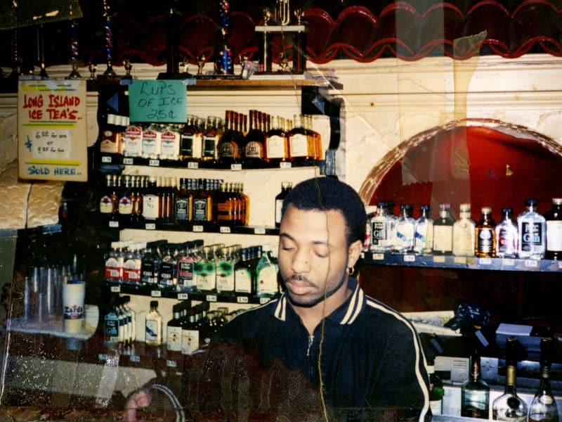 Young Black masculine bartender pouring a drink at Soakie's
